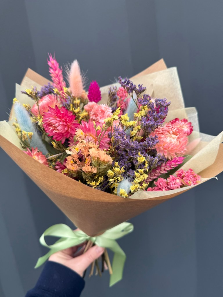 Spring dried flower bouquet in pink, lilac and yellow tones by a Cupar florist, featuring statice, strawflowers and bunny tails in a natural meadow style.